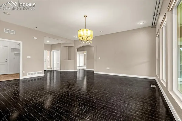 a view of a livingroom with a furniture wooden floor and staircase