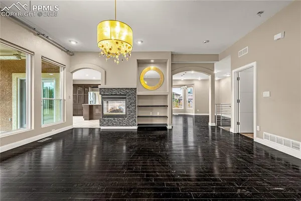 a view of a livingroom with furniture wooden floor chandelier