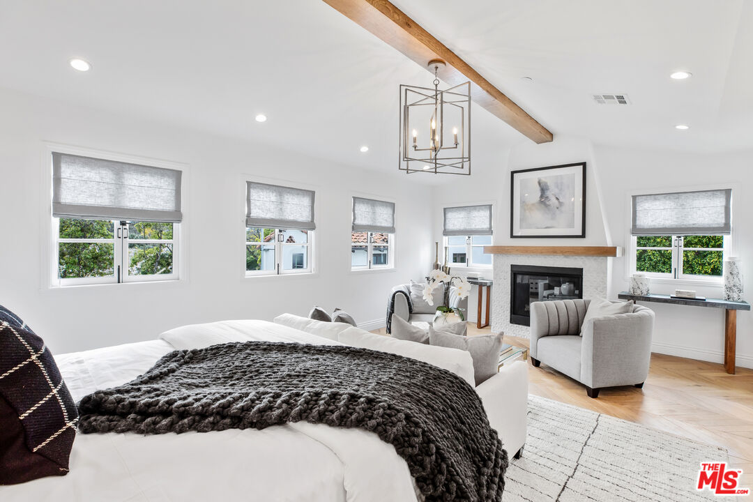 623 Walden Drive Beverly Hills, CA 90210 - Photo 11 of 28 a bedroom with a large bed and a couch