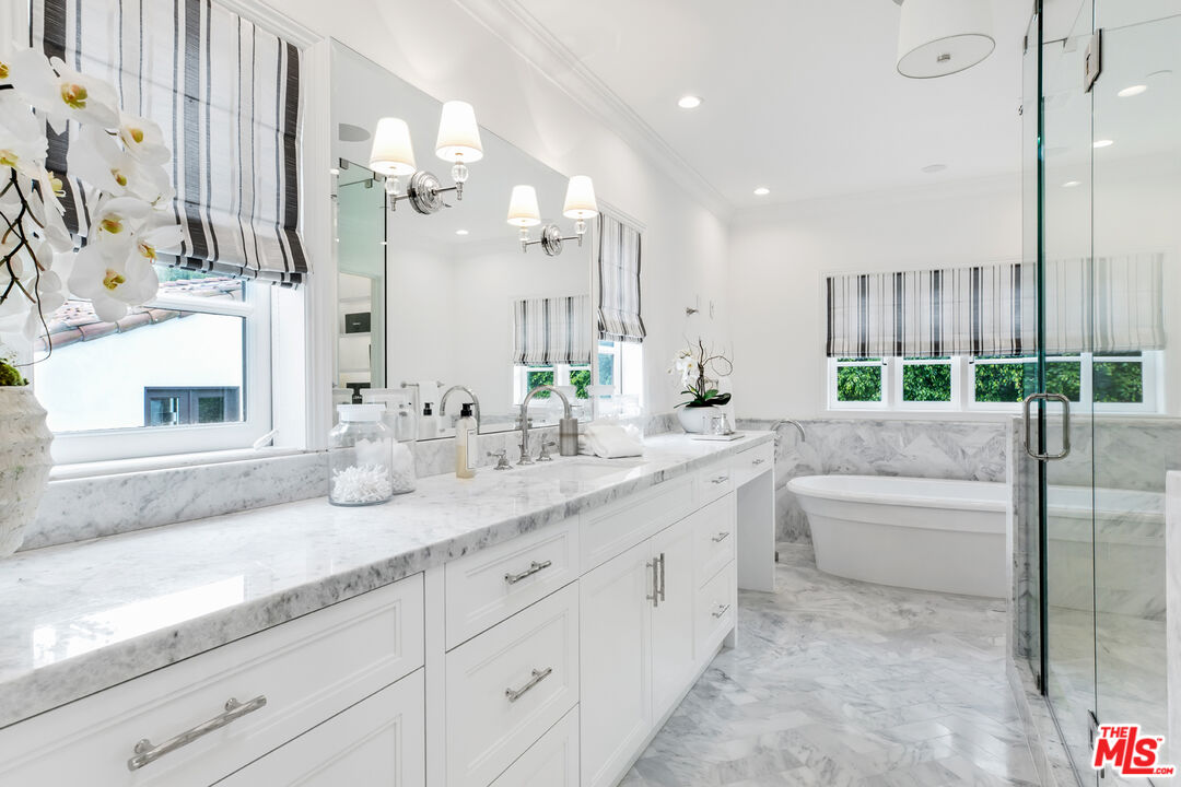 623 Walden Drive Beverly Hills, CA 90210 - Photo 12 of 28 a bathroom with a granite countertop sink a toilet a mirror and shower