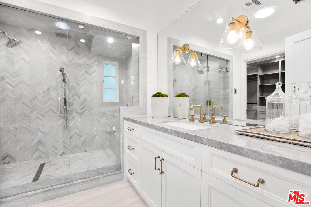 623 Walden Drive Beverly Hills, CA 90210 - Photo 15 of 28 a bathroom with a double vanity sink mirror and shower