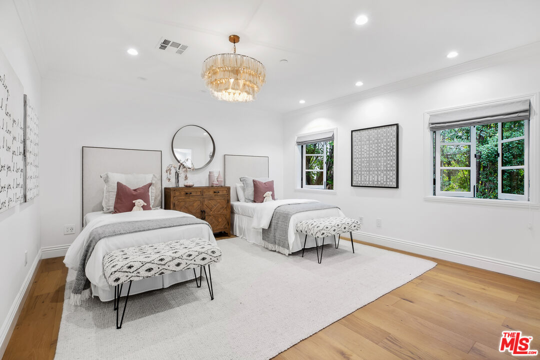 623 Walden Drive Beverly Hills, CA 90210 - Photo 19 of 28 a bedroom with bed and a large window