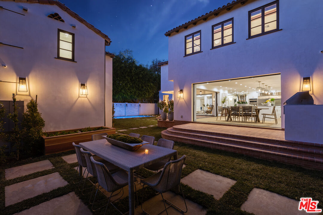 623 Walden Drive Beverly Hills, CA 90210 - Photo 26 of 28 a living room with furniture and a floor to ceiling window