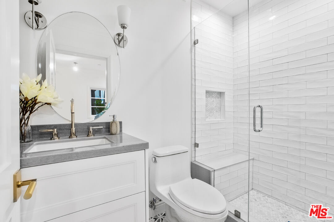 623 Walden Drive Beverly Hills, CA 90210 - Photo 28 of 28 a bathroom with a sink toilet vanity and shower