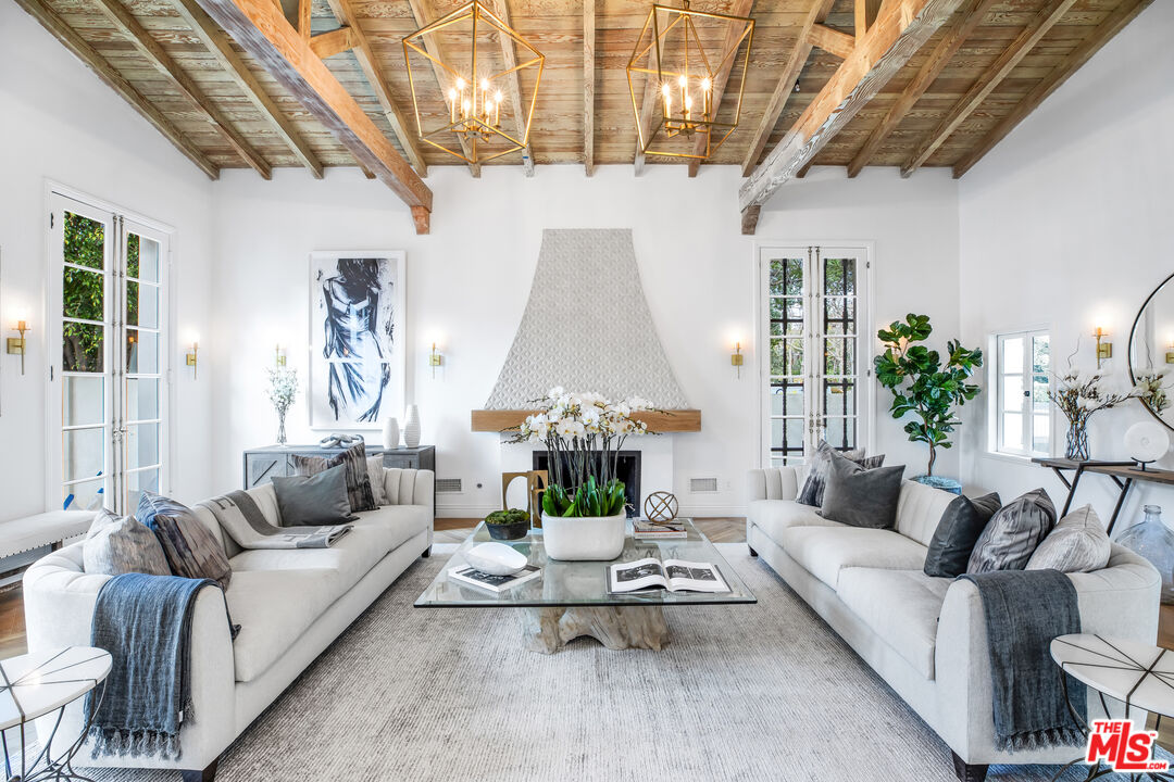 623 Walden Drive Beverly Hills, CA 90210 - Photo 4 of 28 a living room with furniture and a chandelier