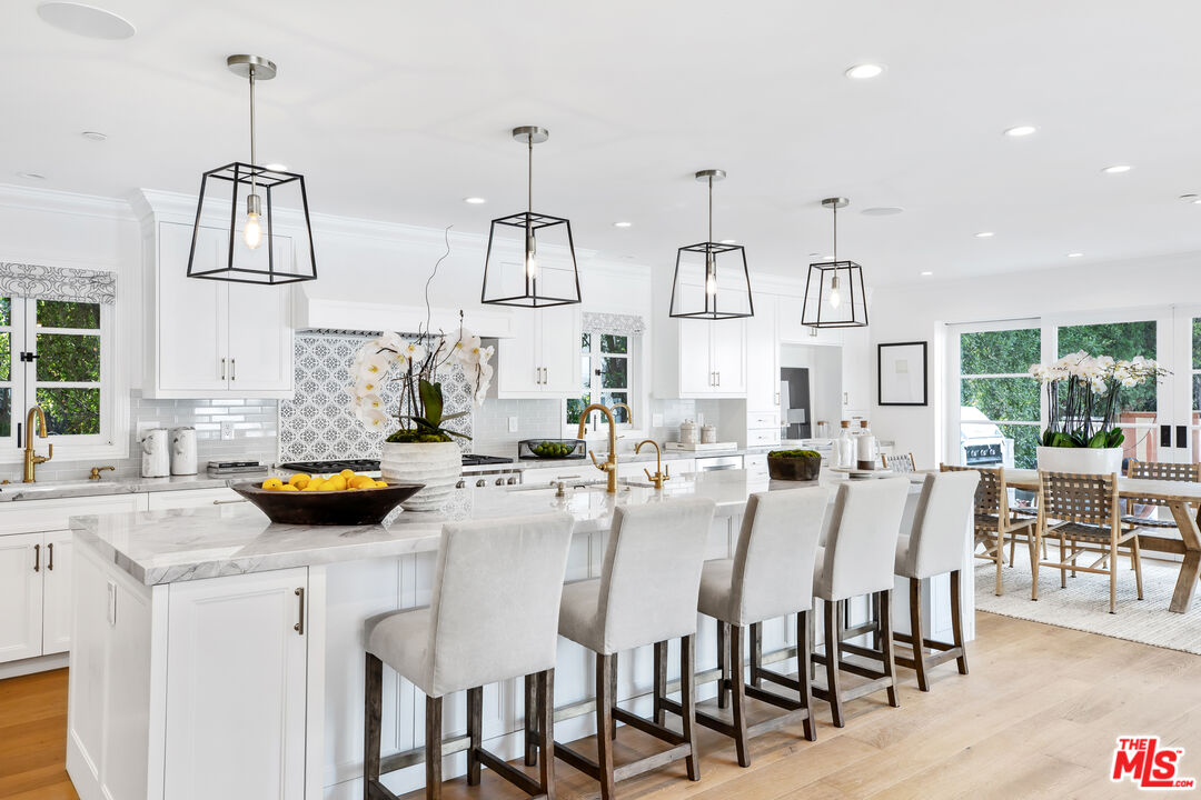 623 Walden Drive Beverly Hills, CA 90210 - Photo 5 of 28 a view of kitchen island dining table and chairs