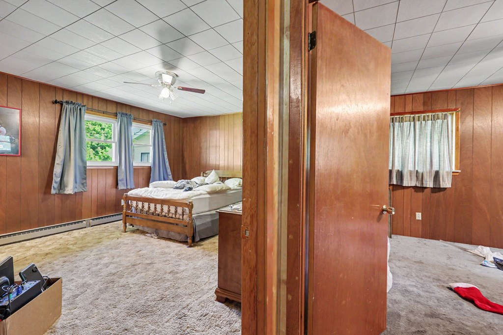 63 Fort Butler Street Murphy, NC 28906 - Photo 17 of 30 a spacious bedroom with a bed and a chandelier