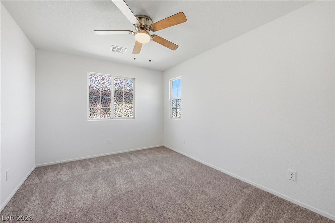 250 Dedication Avenue Henderson, NV 89011 - Photo 34 of 67 Carpeted empty room featuring baseboards and a ceiling fan