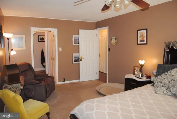 a bedroom with bed and a couch