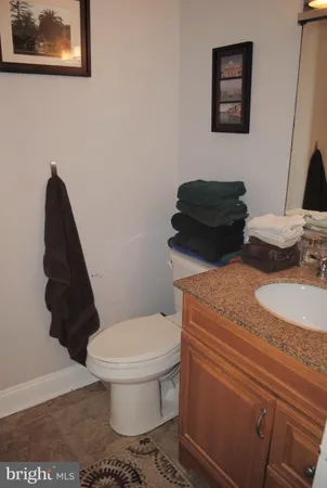 a bathroom with a toilet and a mirror