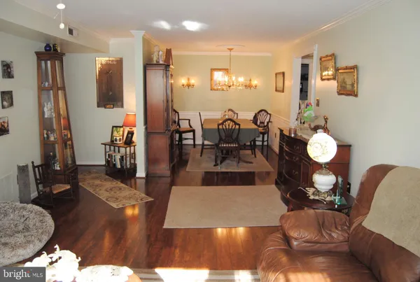 a living room with lots of furniture and wooden floor