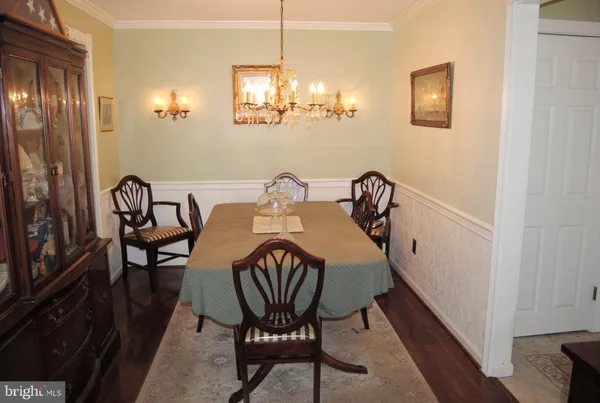a view of a dining room with furniture and chandelier