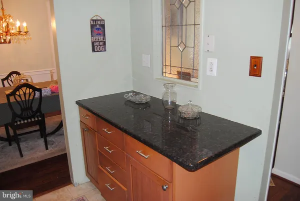 a kitchen with granite countertop a sink a stove and a refrigerator