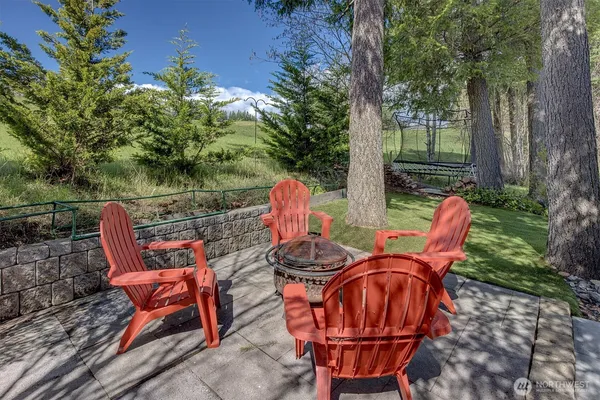an outdoor sitting area with furniture and garden
