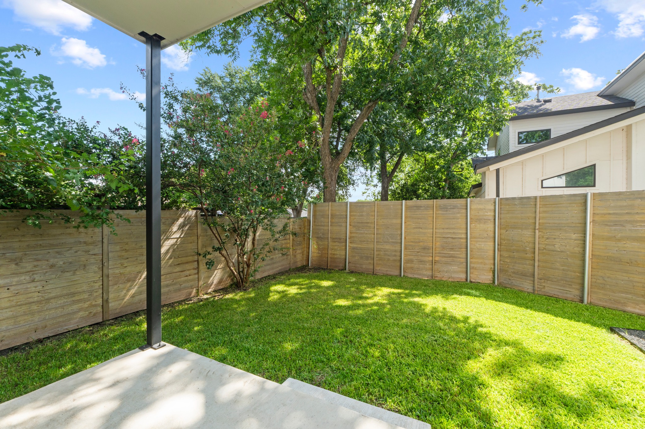 2007 Chestnut Avenue, Unit 1 Austin, TX 78722 - Photo 29 of 32 A fully fenced backyard offers a private green oasis for outdoor enjoyment.