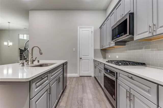 a kitchen with a sink stove and microwave