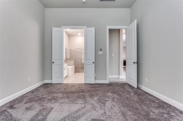 a spacious bathroom with a double vanity sink a mirror and a bathtub