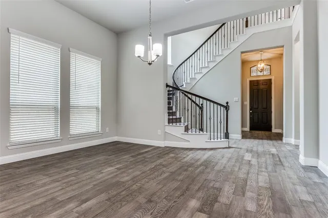 wooden floor in an empty room with a window and wooden floor