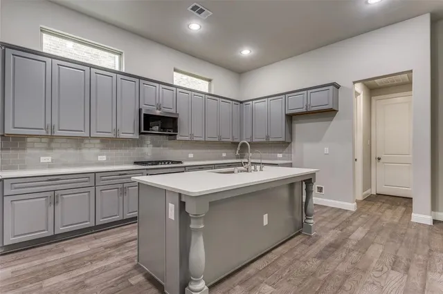 a kitchen with a sink cabinets and stainless steel appliances
