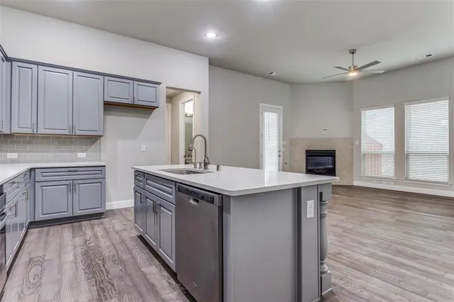 a kitchen with a sink stove and cabinets