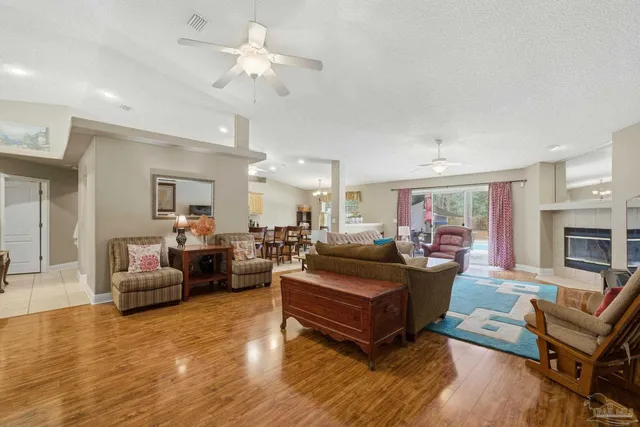 a living room with fireplace furniture and a wooden floor