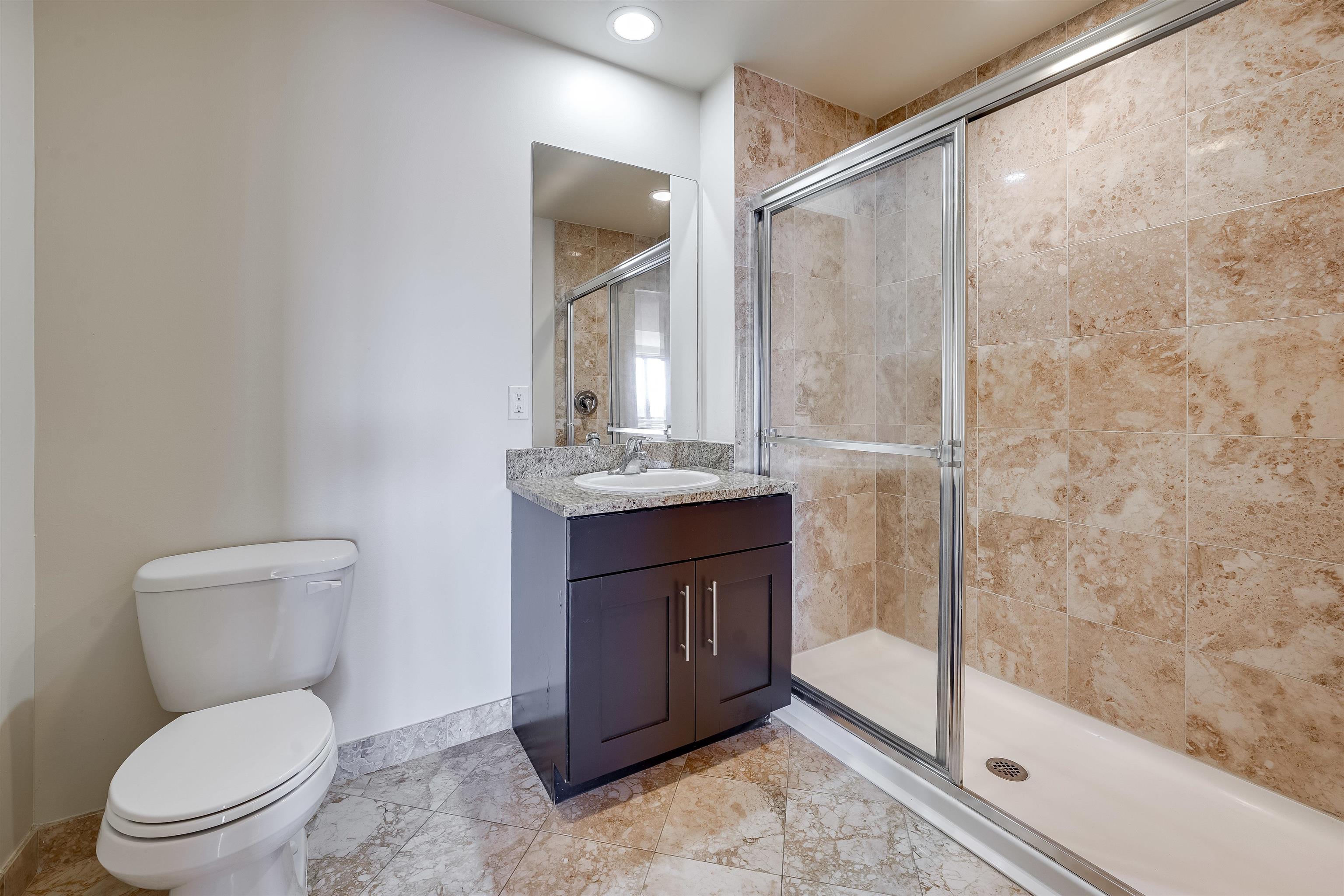 29 1st Street, Unit 401 Hackensack, NJ 07601 - Photo 8 of 23 a bathroom with a toilet a sink and shower