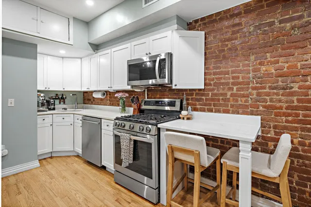 a kitchen with a stove sink and microwave