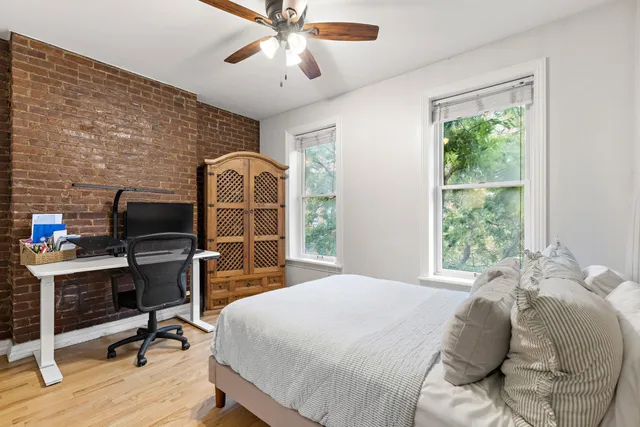 a bedroom with a bed and a desk