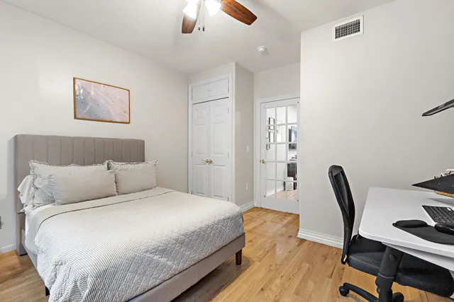 a bedroom with a bed and a chair