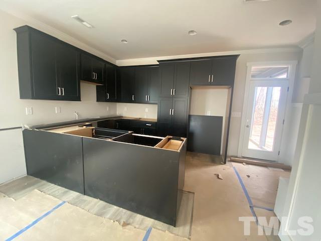 1133 Benning Street Durham, NC 27704 - Photo 22 of 22 a kitchen with stainless steel appliances kitchen island sink refrigerator and fireplace