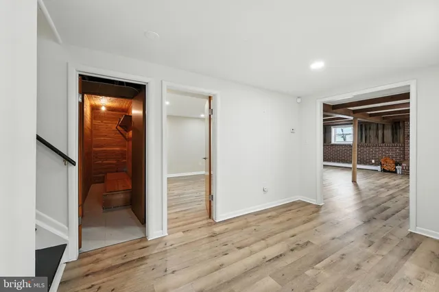 a bathroom with a toilet sink vanity and mirror