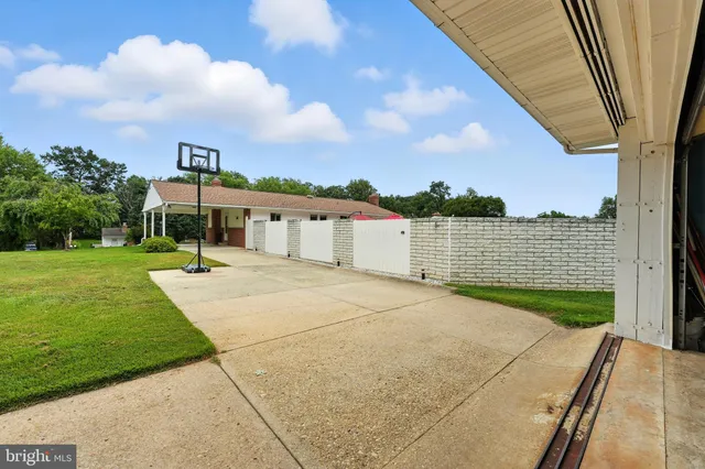 a view of yard with swimming pool and green space