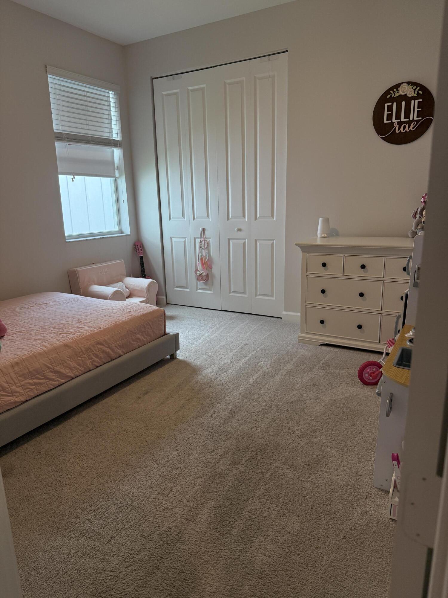 1382 Arrowhead Point Road Loxahatchee, FL 33470 - Photo 11 of 55 a bedroom with a bed dresser and a window