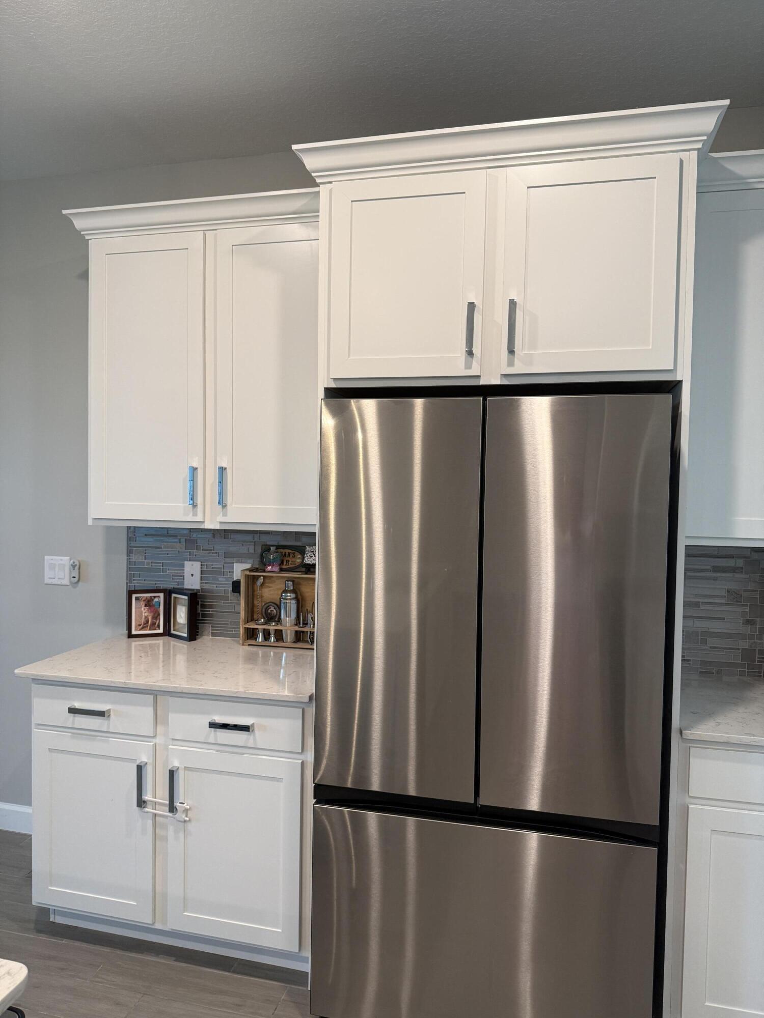 1382 Arrowhead Point Road Loxahatchee, FL 33470 - Photo 18 of 55 a kitchen with a refrigerator a sink and cabinets