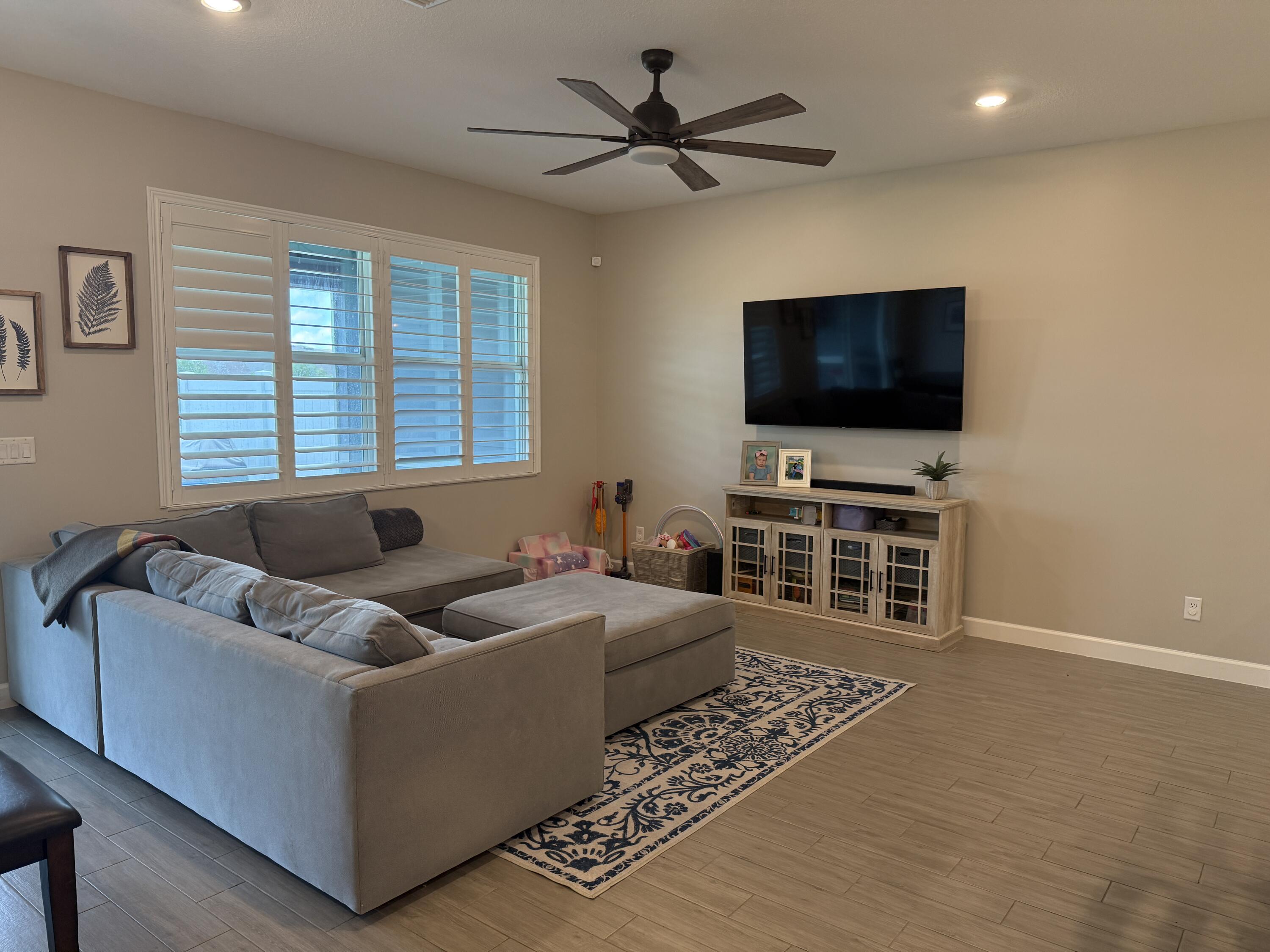 1382 Arrowhead Point Road Loxahatchee, FL 33470 - Photo 23 of 55 a living room with furniture and a flat screen tv