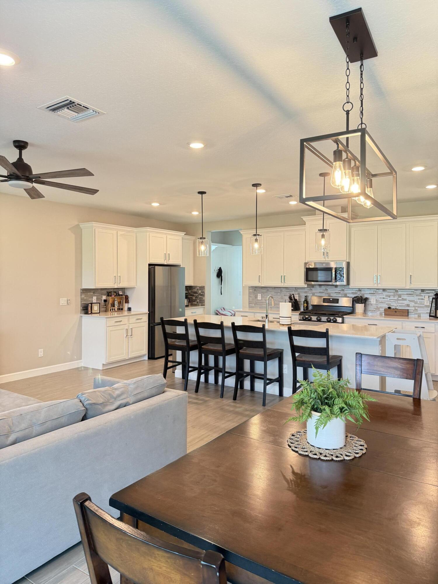 1382 Arrowhead Point Road Loxahatchee, FL 33470 - Photo 25 of 55 a kitchen with a table and chairs