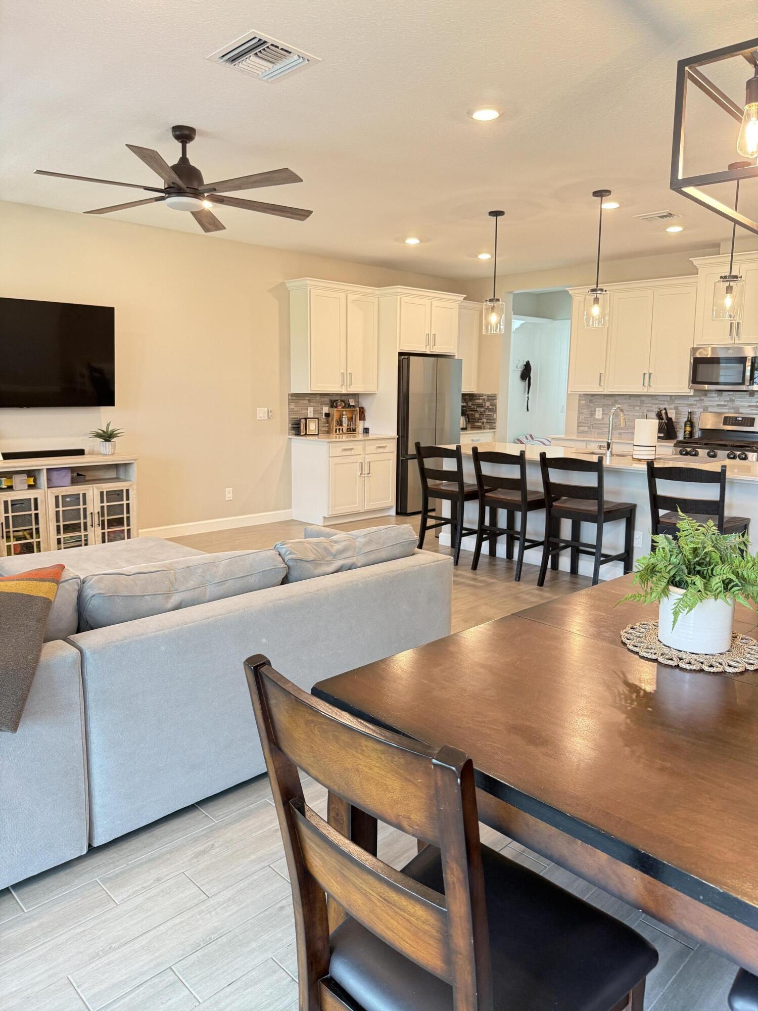 1382 Arrowhead Point Road Loxahatchee, FL 33470 - Photo 26 of 55 a view of a dining room with furniture window and wooden floor