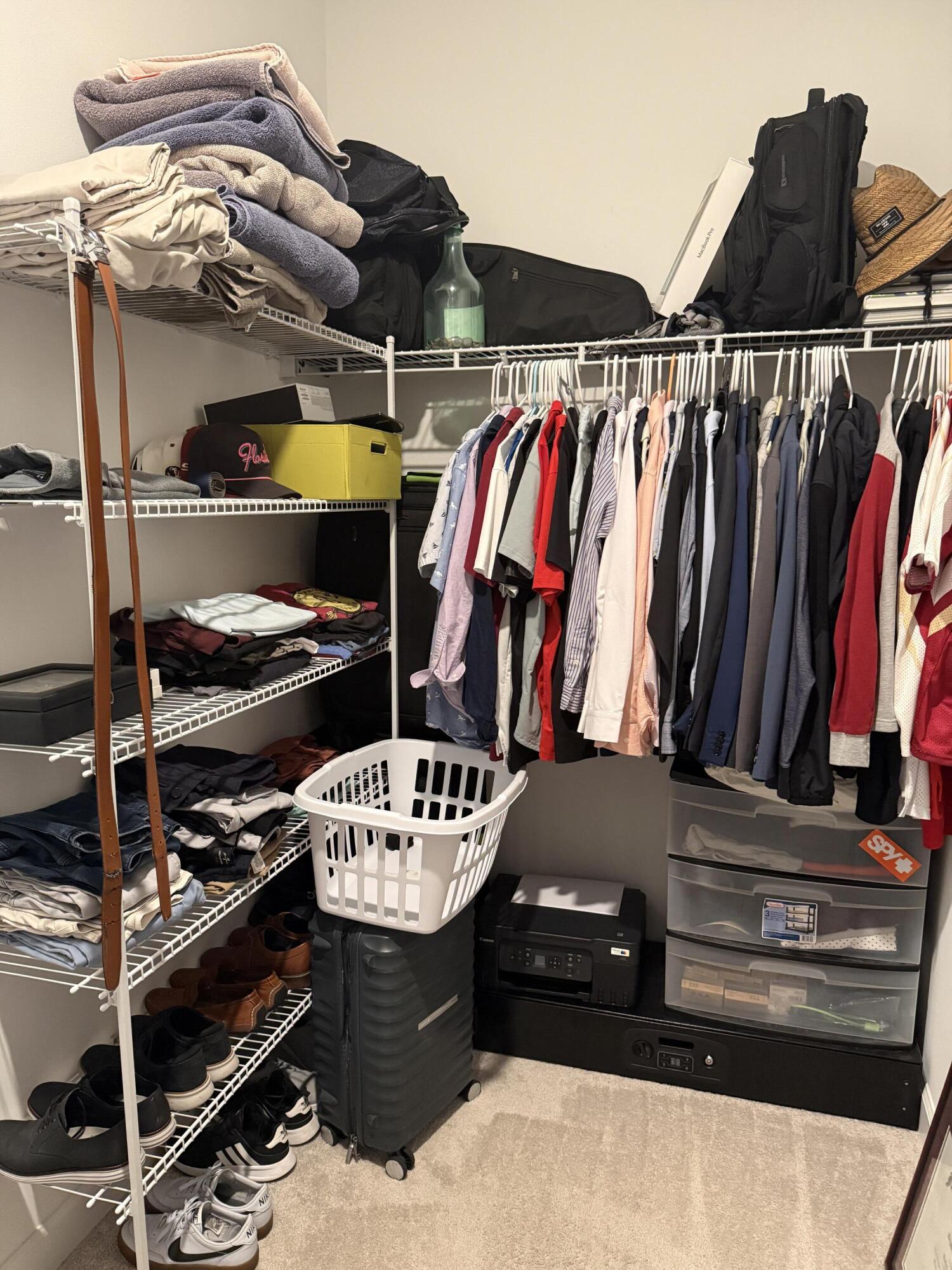 1382 Arrowhead Point Road Loxahatchee, FL 33470 - Photo 36 of 55 a view of walk in closet with clothes and shoes