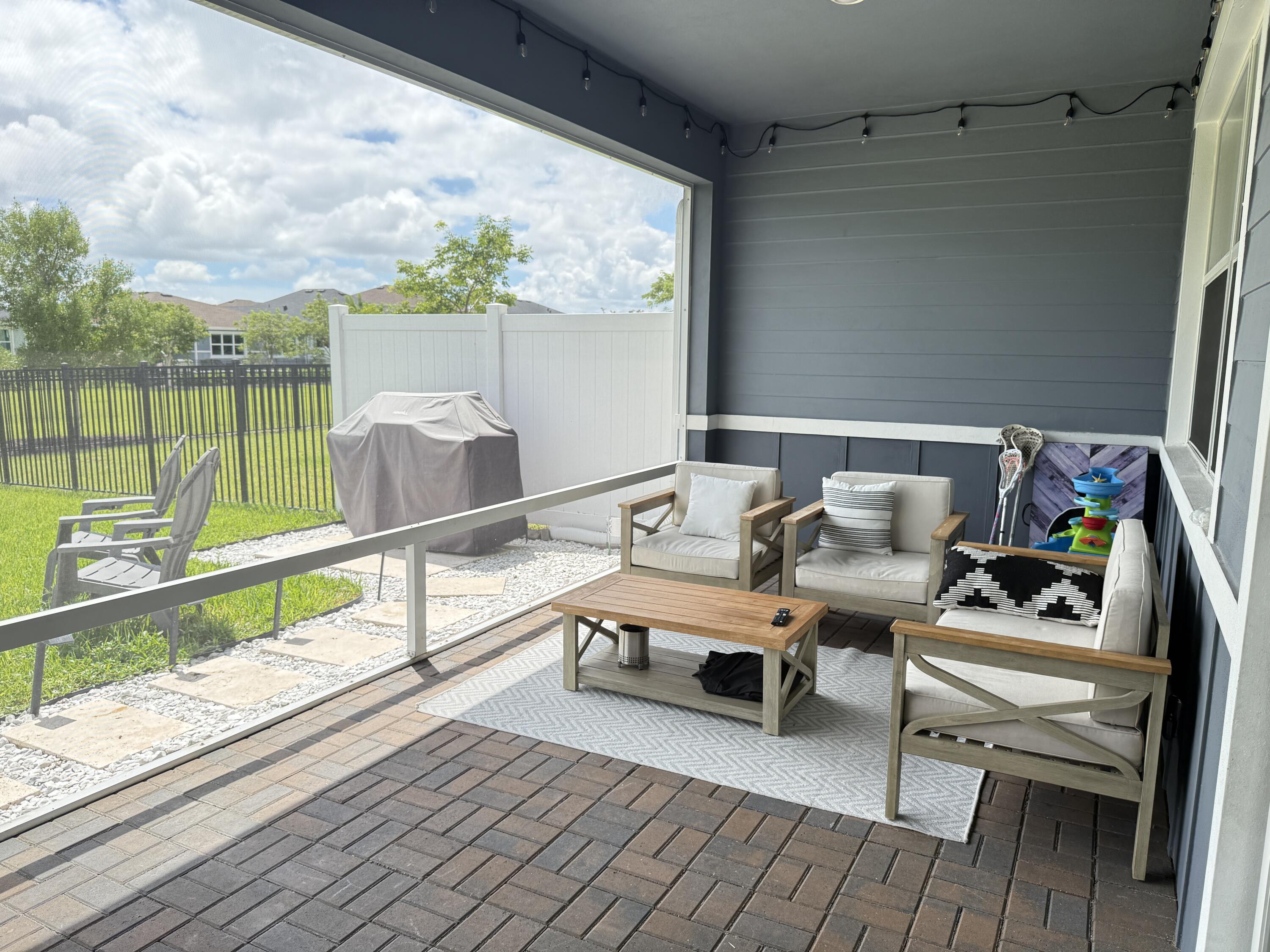 1382 Arrowhead Point Road Loxahatchee, FL 33470 - Photo 37 of 55 a balcony with furniture and a table