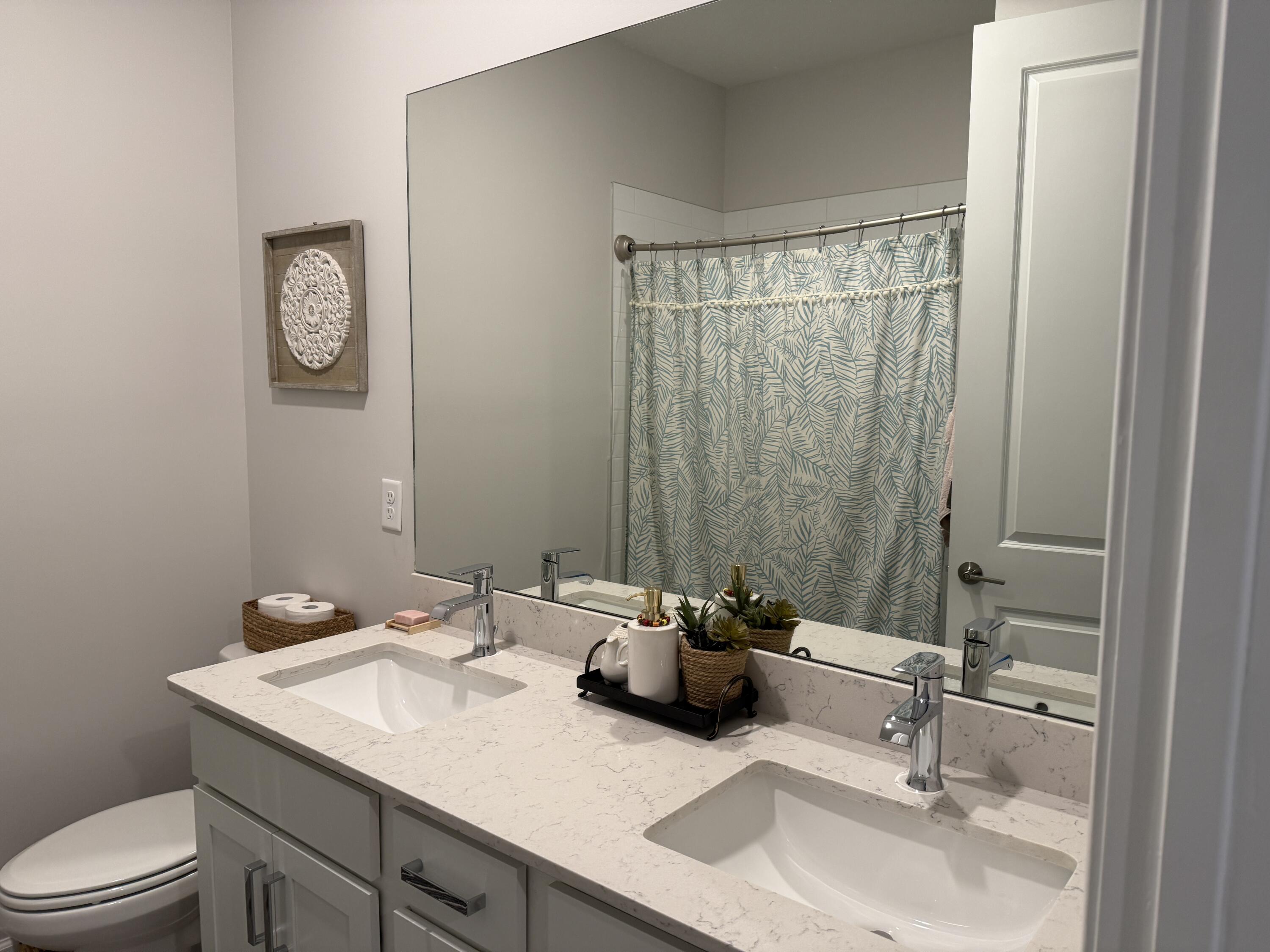 1382 Arrowhead Point Road Loxahatchee, FL 33470 - Photo 10 of 55 a bathroom with a sink and a mirror