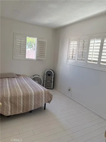 a spacious bedroom with a bed and a window