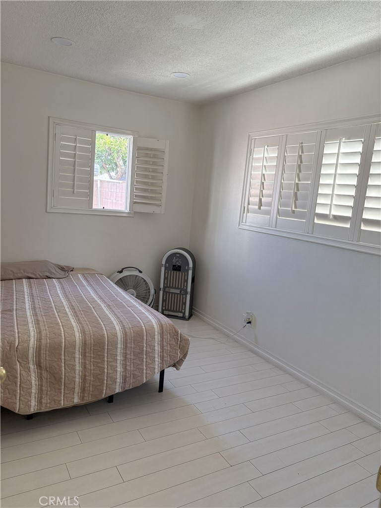 2206 Cowlin Avenue Commerce, CA 90040 - Photo 4 of 8 a spacious bedroom with a bed and a window