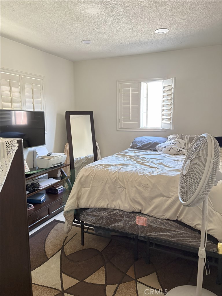 2206 Cowlin Avenue Commerce, CA 90040 - Photo 5 of 8 a bedroom with a bed and wooden floor