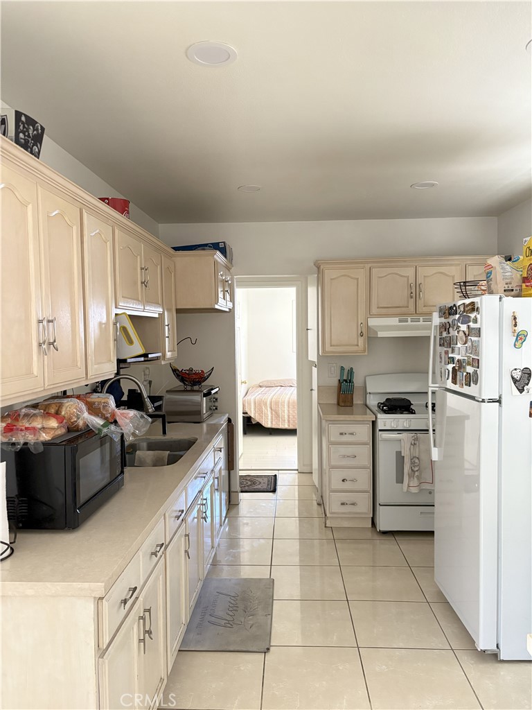 2206 Cowlin Avenue Commerce, CA 90040 - Photo 6 of 8 a kitchen with a stove sink and cabinets