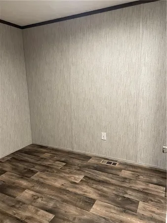 a view of a room with a wooden wall and curtain