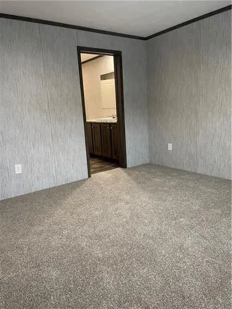 an empty room with mirror and a window