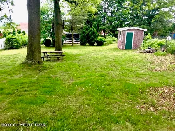 a house with lots of trees in the background
