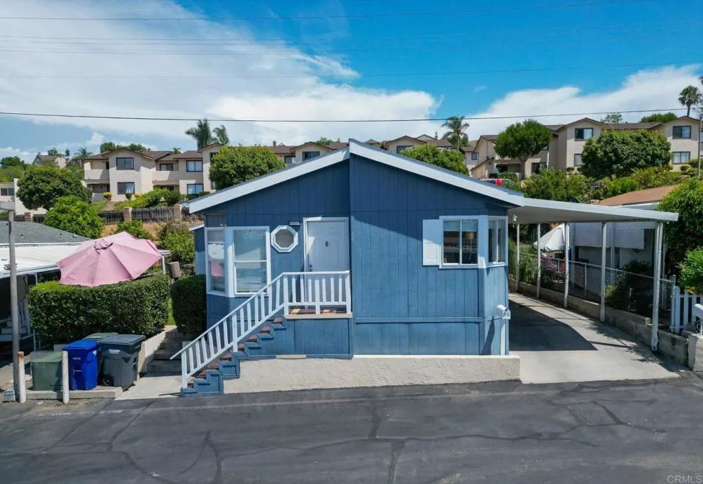 a view of a house with wooden fence