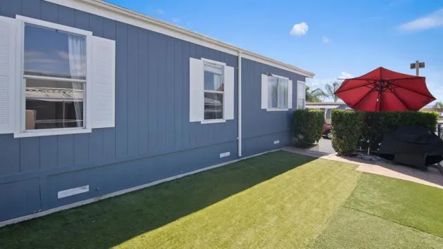 a backyard of a house with table and chairs