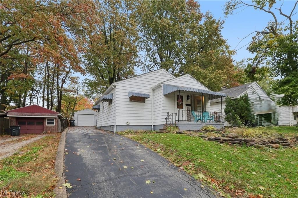 785 Reed Avenue Akron, OH 44306 - Photo 1 of 29 Bungalow-style home featuring an outdoor structure, a garage, covered porch, and a front yard